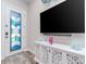 Bright living room features a decorative glass front door and a modern entertainment center at 5526 14Th S Ave, Gulfport, FL 33707
