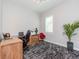 Bright office space showcasing neutral walls, shuttered window, desk, chair, and a patterned rug at 5526 14Th S Ave, Gulfport, FL 33707