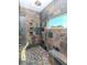 A beautifully tiled shower with a rain shower head, built-in niches, and a convenient bench at 5526 14Th S Ave, Gulfport, FL 33707