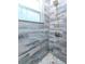 Stylish shower showcasing blue-gray tiles with a mosaic floor, and modern fixtures at 5526 14Th S Ave, Gulfport, FL 33707