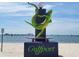 Colorful statue of lizard skateboarding on a sign welcoming to Gulfport, Florida, with view of ocean and boats at 5526 14Th S Ave, Gulfport, FL 33707