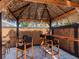 Seating area underneath tiki bar featuring four wood barstools at 5526 14Th S Ave, Gulfport, FL 33707