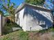 Exterior view of a shed featuring a door, window AC unit, and a vent at 711 Smith St, Clearwater, FL 33756