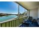 A screened balcony featuring a table and chairs with beautiful views of the water at 7405 Bay Island S Dr # 220, South Pasadena, FL 33707