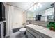 This is a clean bathroom with a shower and bath combination and a decorative black and white floor at 7405 Bay Island S Dr # 220, South Pasadena, FL 33707