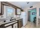 Well-lit kitchen with stainless steel sink, granite countertops, and tiled flooring at 7405 Bay Island S Dr # 220, South Pasadena, FL 33707