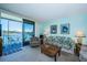 Living room with sliding glass doors to balcony and water view at 7405 Bay Island S Dr # 220, South Pasadena, FL 33707