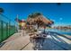 Community picnic area under tiki huts next to the water and tennis court at 7405 Bay Island S Dr # 220, South Pasadena, FL 33707