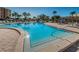 Community swimming pool is surrounded by lounge chairs and mature landscaping at 7405 Bay Island S Dr # 220, South Pasadena, FL 33707