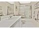 This bathroom features a white vanity with a single sink and shower-tub combo with glass doors at 7435 Woodhollow Rd, Spring Hill, FL 34606