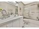 Bright bathroom features a shower-tub combo with glass doors and a white single sink vanity at 7435 Woodhollow Rd, Spring Hill, FL 34606