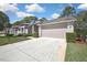 Charming single-story home with a well-manicured front lawn and a two-car garage at 7435 Woodhollow Rd, Spring Hill, FL 34606