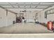 Spacious two-car garage with storage cabinets and shelving for tools and equipment at 7435 Woodhollow Rd, Spring Hill, FL 34606