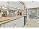 Bright kitchen with white cabinets and granite countertops, seamlessly connected to the dining area at 7435 Woodhollow Rd, Spring Hill, FL 34606