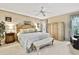 Comfortable main bedroom featuring neutral tones, a ceiling fan, and a king-size bed at 7435 Woodhollow Rd, Spring Hill, FL 34606