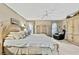 Comfortable main bedroom featuring neutral tones, a ceiling fan, and a king-size bed at 7435 Woodhollow Rd, Spring Hill, FL 34606