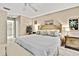 Comfortable main bedroom with neutral tones, a ceiling fan, and access to the bathroom at 7435 Woodhollow Rd, Spring Hill, FL 34606