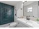 Updated bathroom with tiled shower, matte black hardware, and granite counters at 7480 Hobson Ne St, St Petersburg, FL 33702