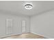 Bright bedroom with two windows and light-colored, wood-look vinyl flooring at 7480 Hobson Ne St, St Petersburg, FL 33702