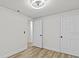 Bedroom with updated fan, light wood look floors, and two closets at 7480 Hobson Ne St, St Petersburg, FL 33702