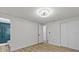 Bedroom with updated fan, light wood look floors, and closet at 7480 Hobson Ne St, St Petersburg, FL 33702