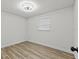 Neutral bedroom with wood-look flooring and modern ceiling fan at 7480 Hobson Ne St, St Petersburg, FL 33702