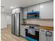 Kitchen with stainless steel appliances and bright blue accents at 7480 Hobson Ne St, St Petersburg, FL 33702