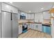 Modern kitchen with stainless steel appliances and grey cabinets at 7480 Hobson Ne St, St Petersburg, FL 33702