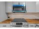 Stove top close up featuring modern appliances and wooden countertops at 7480 Hobson Ne St, St Petersburg, FL 33702