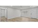 A view of the white living room featuring a window and white door at 7480 Hobson Ne St, St Petersburg, FL 33702