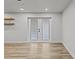 Bright sunroom with wood floors and double doors to backyard at 7480 Hobson Ne St, St Petersburg, FL 33702