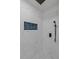 Stylish marble tiled shower with black fixtures and mosaic tile floor at 7480 Hobson Ne St, St Petersburg, FL 33702