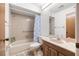 Bathroom with tub-shower combo with tile surround, toilet, and vanity at 7703 Rockville Ct # 0, New Port Richey, FL 34654