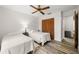 Bedroom with two beds, wood flooring, a ceiling fan, and wood closet doors at 7703 Rockville Ct # 0, New Port Richey, FL 34654