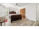 Bedroom with wood-look flooring, a ceiling fan, and a spacious closet at 7703 Rockville Ct # 0, New Port Richey, FL 34654