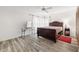 Bedroom featuring wood-look flooring, ceiling fan, large window, and closet at 7703 Rockville Ct # 0, New Port Richey, FL 34654