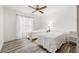 Bedroom featuring two beds, wood flooring, a ceiling fan, and window with curtains at 7703 Rockville Ct # 0, New Port Richey, FL 34654