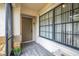 Inviting front entryway featuring a tiled porch, large windows, and a secure door at 7703 Rockville Ct # 0, New Port Richey, FL 34654