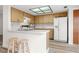 Well-lit kitchen featuring a breakfast bar, modern appliances, and ample counter space at 7703 Rockville Ct # 0, New Port Richey, FL 34654