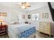 Cozy bedroom with a ceiling fan, two windows, a dresser, and a comfortable bed at 7825 38Th N Ter # 7825, St Petersburg, FL 33709