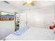 Bright bedroom with a ceiling fan, a flat-screen TV, closet doors, and connecting doorway at 7825 38Th N Ter # 7825, St Petersburg, FL 33709