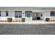 Charming single-story home with a light green front door, decorative stone accents, and a convenient attached carport at 7825 38Th N Ter # 7825, St Petersburg, FL 33709