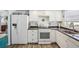 Well-lit kitchen with white cabinets, stainless steel appliances, and a sink near the window at 7825 38Th N Ter # 7825, St Petersburg, FL 33709