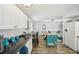 Bright kitchen with white cabinets, island, and modern appliances flows into living area at 7825 38Th N Ter # 7825, St Petersburg, FL 33709