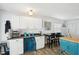Bright kitchen featuring white cabinetry, a breakfast bar, and modern appliances at 7825 38Th N Ter # 7825, St Petersburg, FL 33709