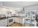 Bright kitchen with white cabinets, modern appliances, and slider to outdoor space at 7825 38Th N Ter # 7825, St Petersburg, FL 33709