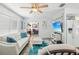 Cozy living room featuring a plush white sofa with blue pillows and a view of the adjacent kitchen and dining area at 7825 38Th N Ter # 7825, St Petersburg, FL 33709
