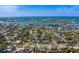 Stunning aerial view of waterfront homes and community with lush green landscaping and bright blue water views at 809 Royal Dr, Largo, FL 33770