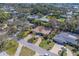 Overhead view of a well-maintained property with lush landscaping, brick driveway, and tile roof in a mature neighborhood at 809 Royal Dr, Largo, FL 33770