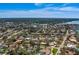 High-angle view displays houses, well-kept yards, and proximity to a vast body of water at 809 Royal Dr, Largo, FL 33770